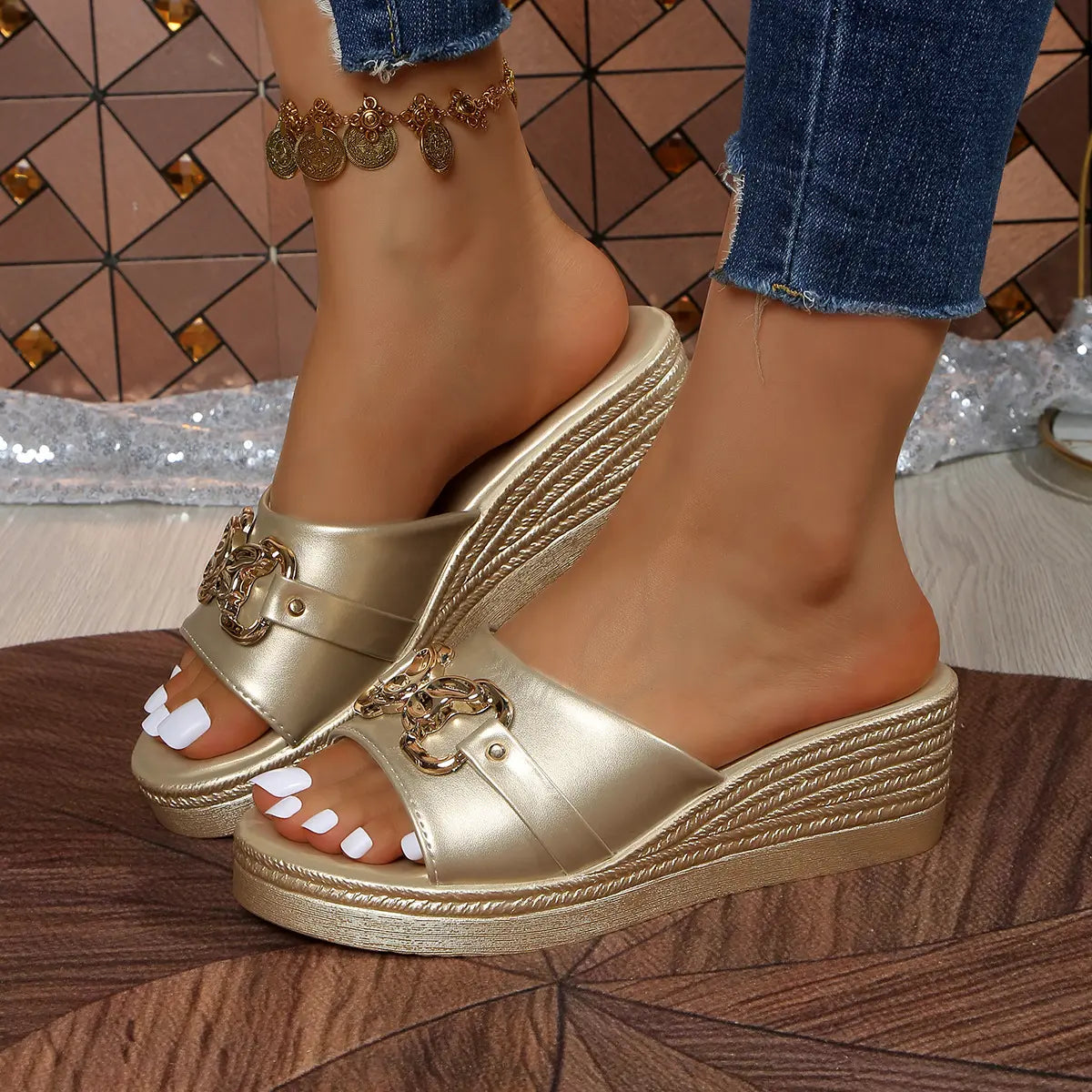 Women's Xyloen gold metallic chain detail peep-toe wedge slide sandals worn with denim jeans and an anklet.