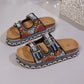 Platform slide sandals in rose pink fabric embellished with intricate beads and sequins, featuring double adjustable buckle straps and a cork-effect platform sole.