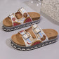 Xylos embellished platform slide sandals in white fabric with vibrant bead and sequin floral patterns, featuring double adjustable buckle straps and a cork-effect layered sole.