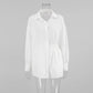 White Xylos textured cotton shirt and shorts set, featuring an oversized relaxed-fit shirt with a camp collar and elasticated-waist shorts. The subtle dot weave fabric offers a breathable, elegant bohemian style for summer.
