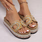 Yellow embellished platform slide sandals with cork footbed and colorful woven midsole, worn on feet with white toenails.