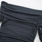 Close-up view of a charcoal grey Zavala off-the-shoulder mini dress, showcasing intricate all-over asymmetrical ruching and draped neckline detail.