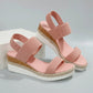 Zaylin Rose Quartz Pink espadrille wedge sandals for women, featuring a peep-toe design, textured mesh upper with elasticated straps, and a multi-layered platform with jute rope detail.