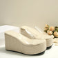 Zelka women's wedge slide sandals featuring transparent PVC straps and a natural beige espadrille-wrapped wedge sole with a platform toe. This image shows a three-quarter view of the summery footwear.