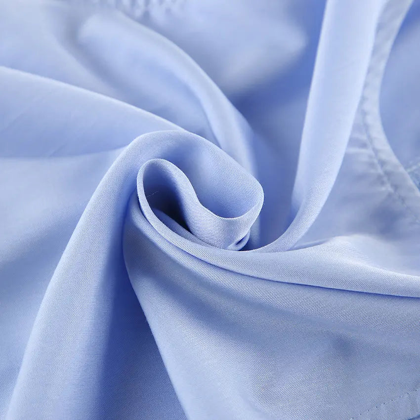 Close-up view of the soft, flowing light blue fabric with delicate ruffle detail and visible stitching, highlighting the premium cotton blend material of the Zelphira Bohemian Set.