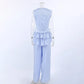 Zelphira two-piece set shown from the back, featuring a sleeveless ruffled crop top and matching wide-leg trousers in light blue, displayed on a mannequin.