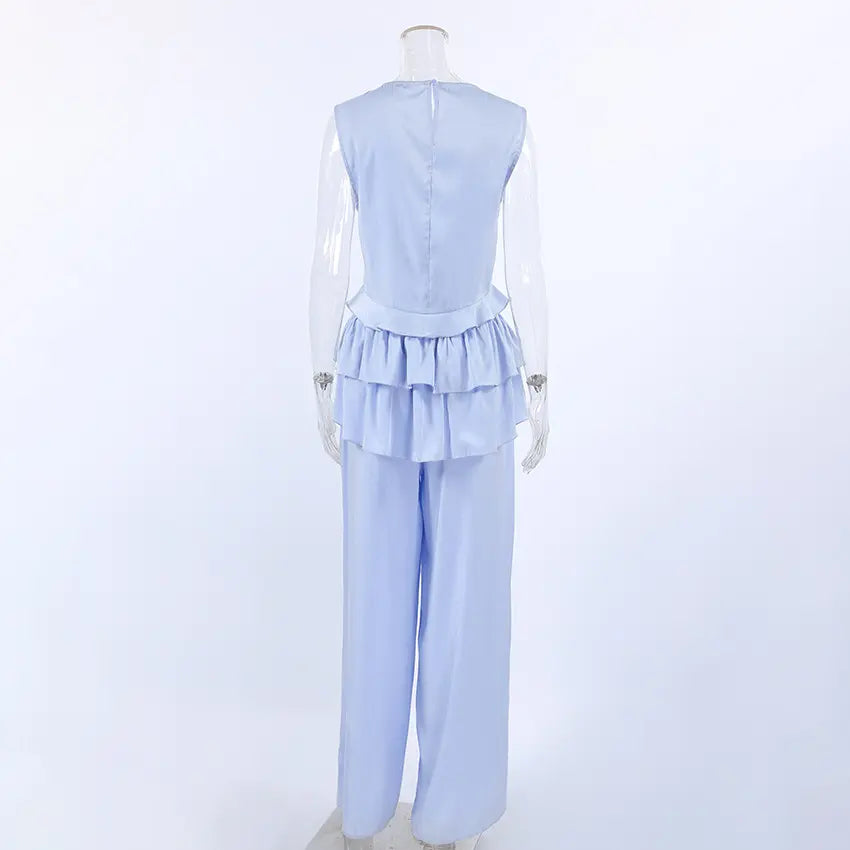 Zelphira two-piece set shown from the back, featuring a sleeveless ruffled crop top and matching wide-leg trousers in light blue, displayed on a mannequin.
