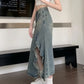 Zendru high-waisted vintage blue denim midi skirt on a woman, showcasing its asymmetrical ruffled front slit and elegant flowing silhouette.