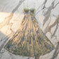 Zenthos Sage Botanical Mesh Floral Maxi Dress with gathered sweetheart bust and blue-green paisley print, displayed flat on a marble surface.