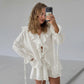 Woman wearing an ivory cream bohemian ruffle set with a V-neck tie blouse and relaxed-fit shorts, captured in a natural selfie style.