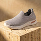 Zhivra women's Cloud Grey knit slip-on sneaker, showcasing breathable perforated upper, ribbed collar, and thick white wedge sole with a subtle peach accent.