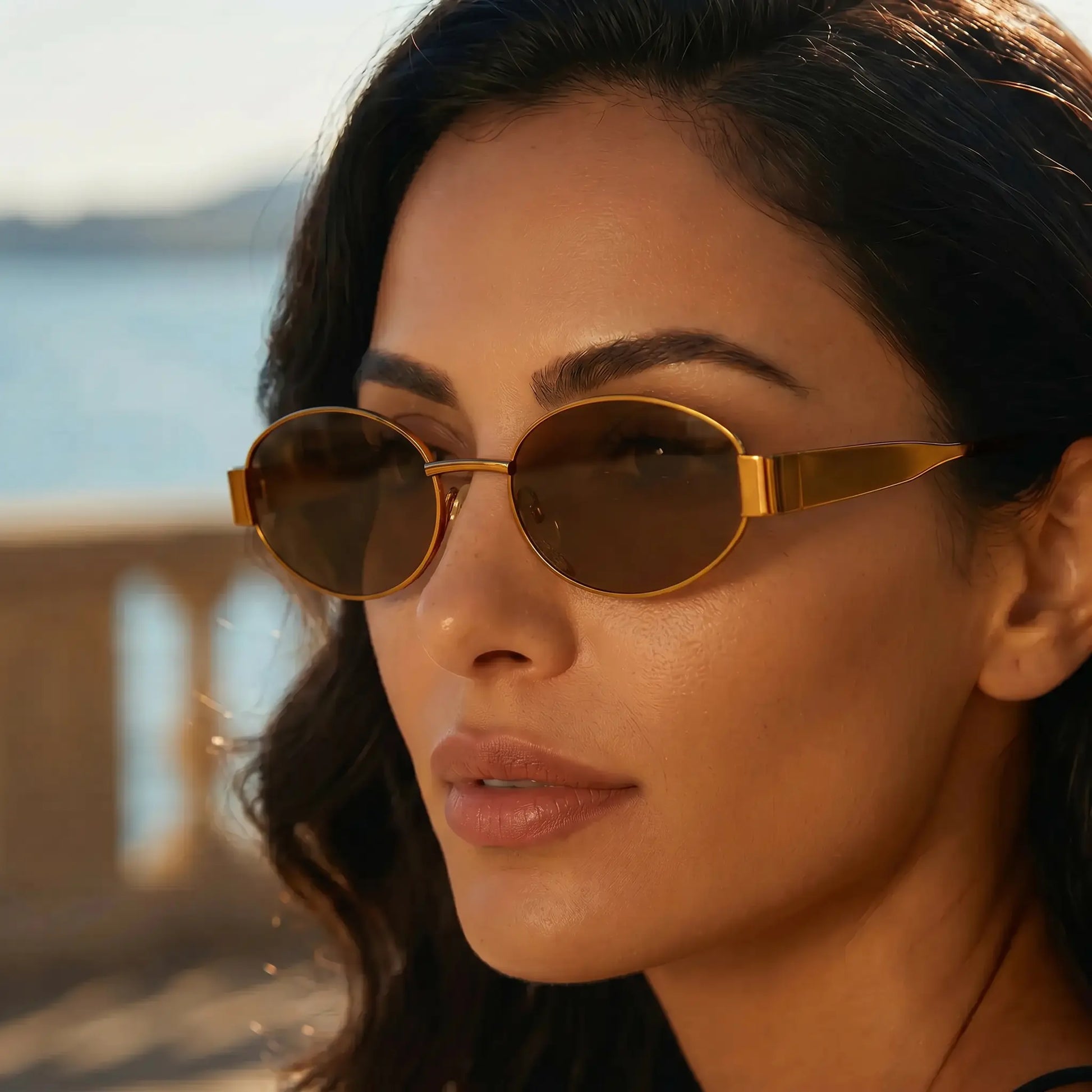 Woman wearing Zokari vintage oval metal frame sunglasses in Classic Gold with Amber Brown lenses, styled for an outdoor lifestyle.