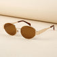 Gold and tortoiseshell Zokari vintage oval metal frame sunglasses with dark tinted lenses, shown at a three-quarter angle.