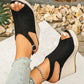 Black peep-toe espadrille wedge sandals worn by a woman, showcasing the jute-wrapped extra-high wedge heel, adjustable ankle strap, and matte suede-like upper material.