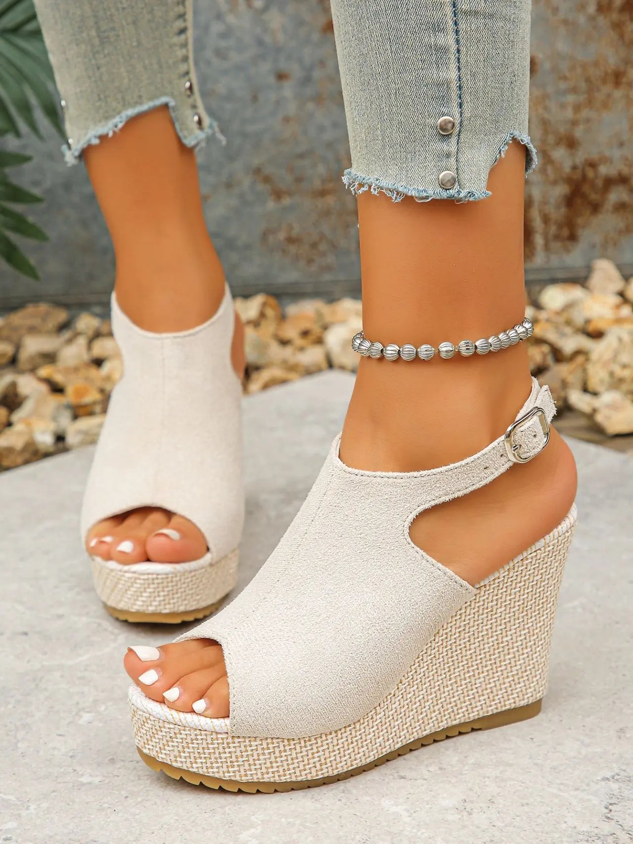 Model wearing Zoltan Earthy Beige peep-toe espadrille wedge sandals with jute-wrapped heel and buckle ankle strap, paired with distressed denim jeans.