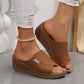 Light brown Zoltar women's comfortable platform slide sandals with a single wide strap, open toe, and a layered wedge sole, styled with white ripped jeans and a pearl anklet.