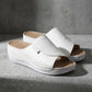 White Zoltar women's slide sandals featuring an open toe, single wide strap, and a layered wedge sole with subtle contrast stitching, shown at a three-quarter angle.