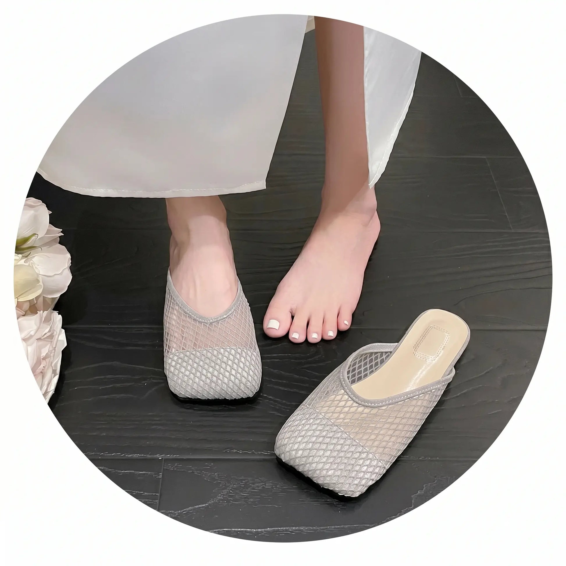 Light grey breathable mesh mules with a square toe, worn by a model on a dark floor, showcasing their airy texture and elegant slip-on style.