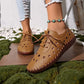 Model's feet wearing Zoryn women's breathable perforated loafers in rich brown, paired with distressed denim jeans and a turquoise anklet.