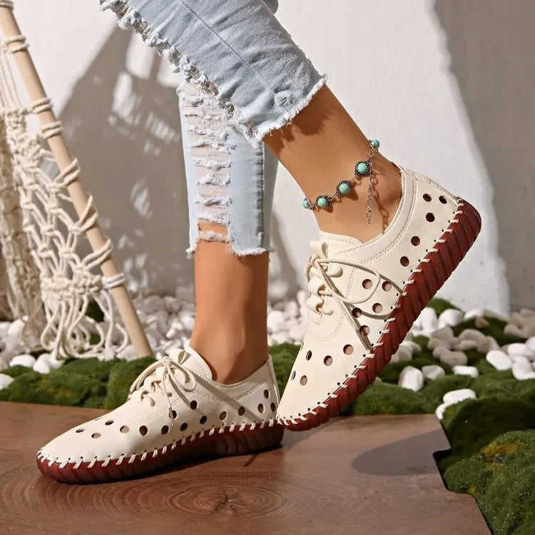 Off-white perforated lace-up loafers styled with distressed jeans and a turquoise ankle bracelet, showcasing bohemian summer comfort.