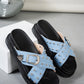 Zoryn studded platform slide sandals in light blue denim-look textile with ornate silver buckles and thick black soles. Displayed at a three-quarter angle on a studio floor.