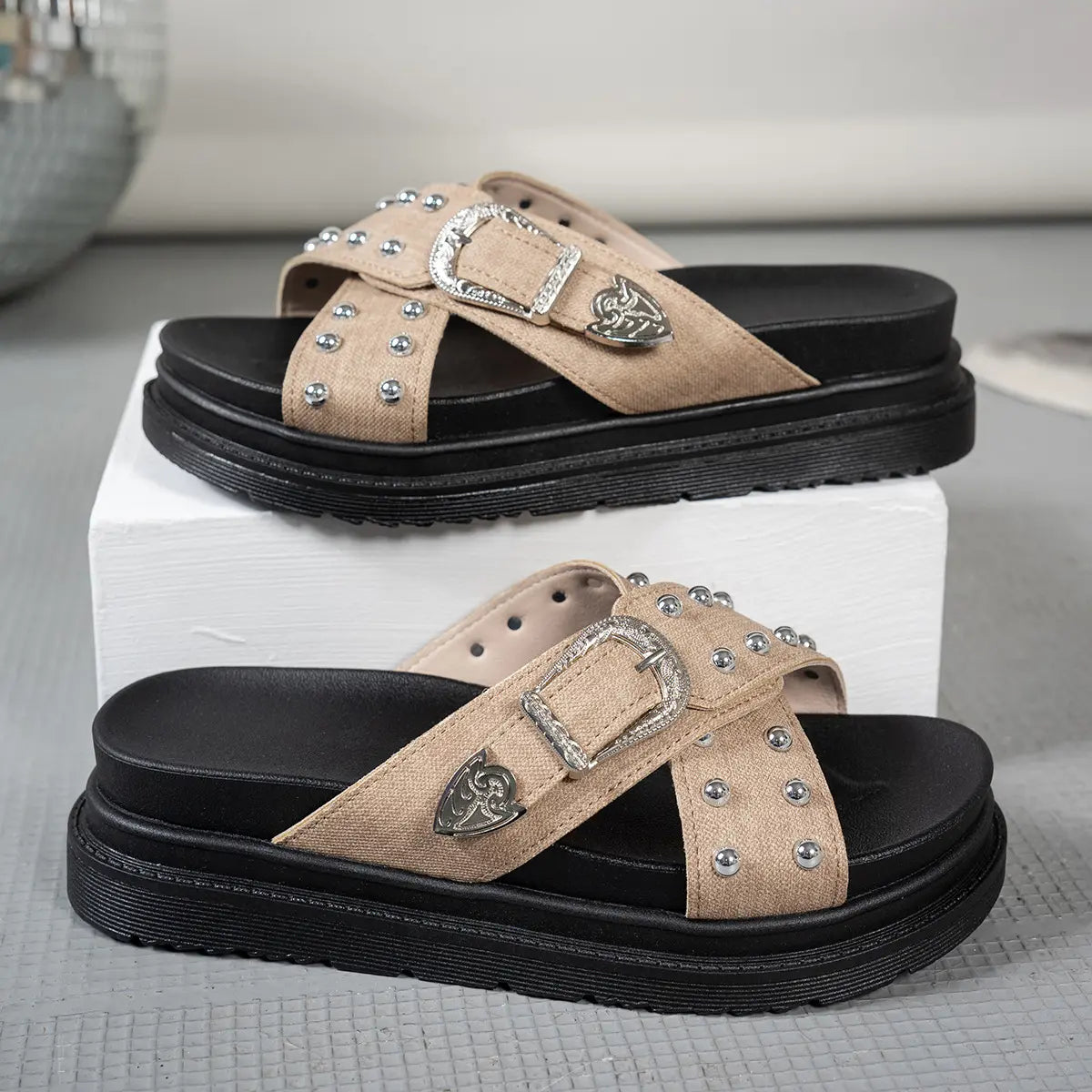 Zoryn platform slide sandals in light beige textile featuring all-over silver stud embellishments and an ornate silver buckle detail on the cross strap.