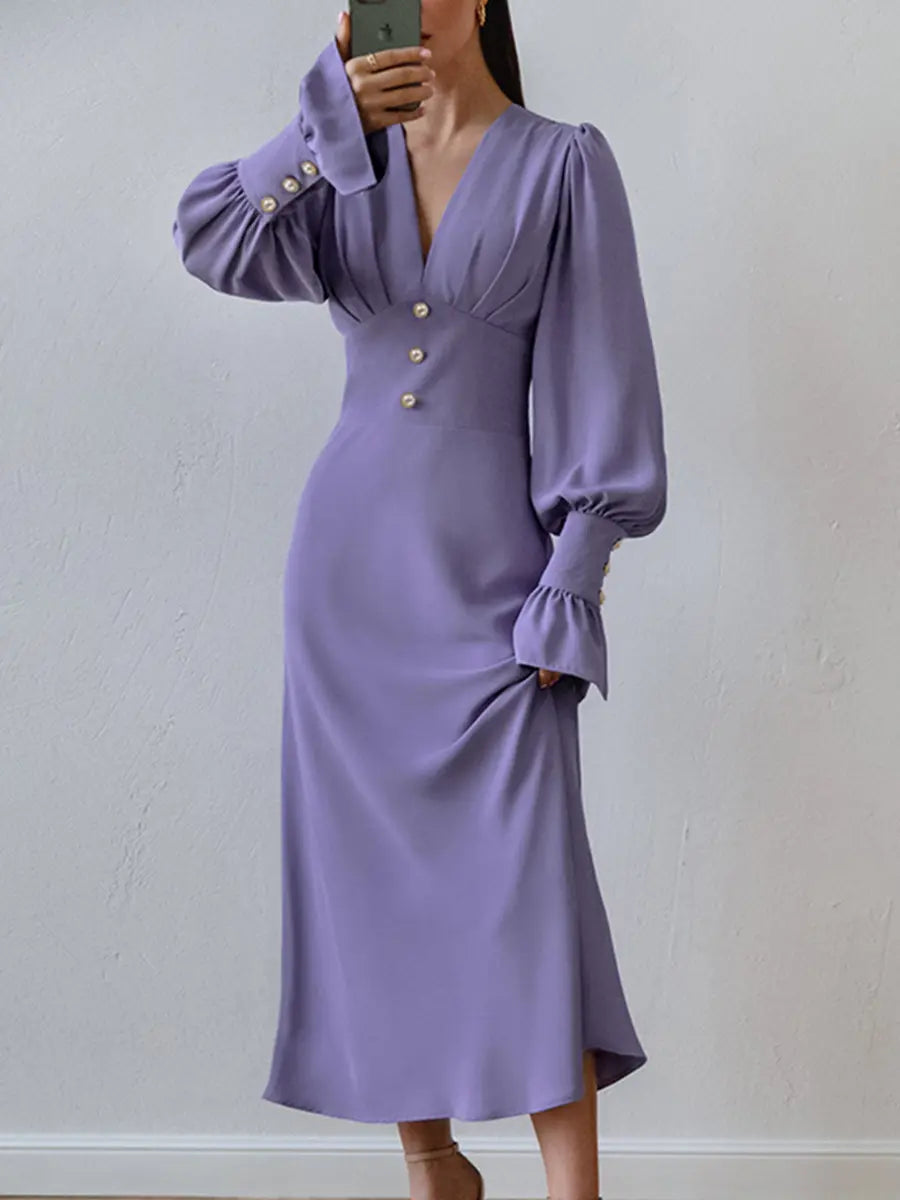Elegant lilac chiffon midi dress with romantic V-neck, voluminous bishop sleeves, and pearl button details, shown worn by a model.