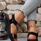 Close-up lifestyle shot of women's Zykla comfort sport sandals in black, worn by a model with light-wash denim jeans featuring frayed hems.