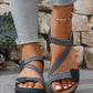 Zykla women's dark blue and beige elastic strap comfort sandals worn with light-wash jeans, showcasing criss-cross straps and PU accents.