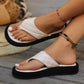 Close-up lifestyle shot of white quilted PU platform thong sandals on a woman's feet, showcasing the thick black sole and bohemian anklets.
