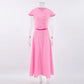 Zylia elegant pink cotton two-piece set featuring a cropped short-sleeve top and a button-front A-line midi skirt, displayed front view on a white background.