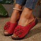 Red Zylia women's open-toe slip-on sandals featuring a large, layered floral embellishment and perforated faux leather straps, worn with denim jeans and a pearl anklet.