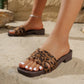 Zyloria women's leopard print flat slide sandals with square toe and layered faux suede straps, shown on a sandy beach with a low wood-effect stacked heel.