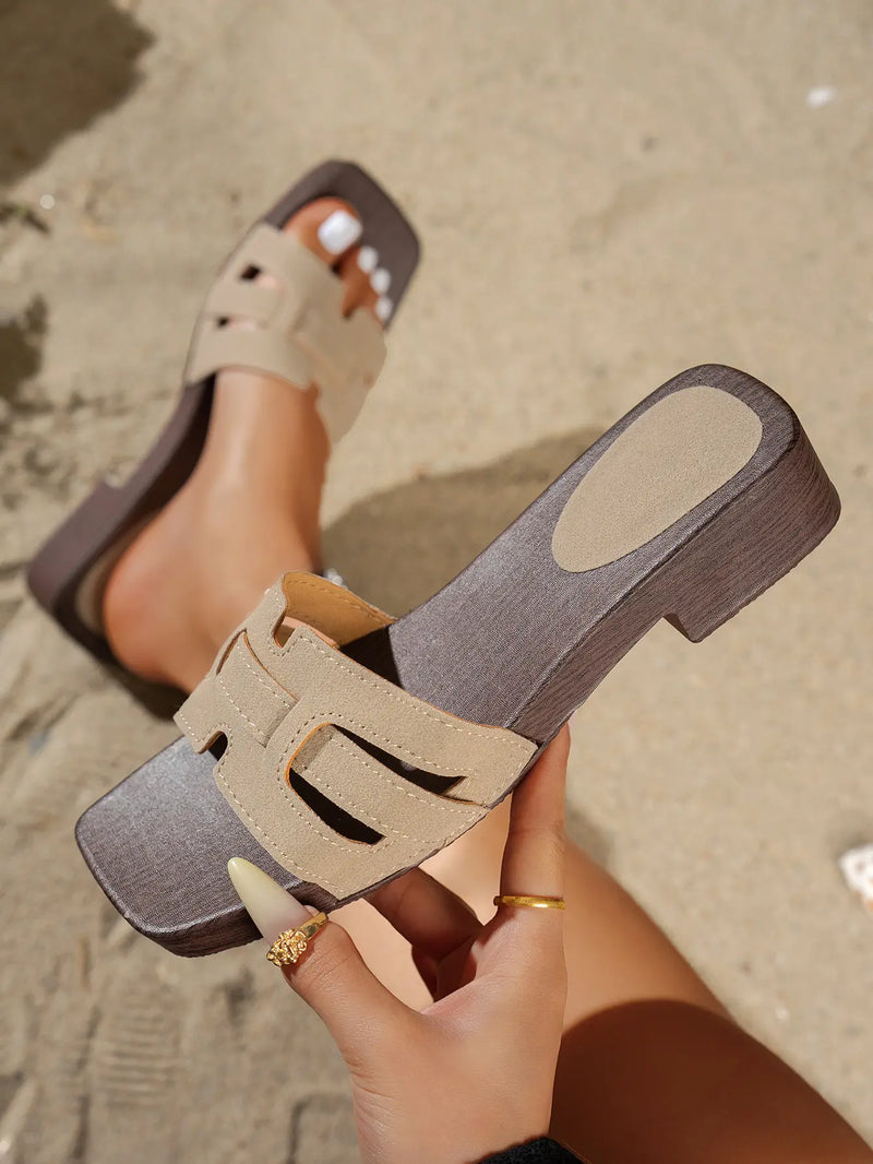 Chic Zyloria women's flat slide sandals featuring a square toe, layered faux suede straps in beige with a leopard print detail, and a dark brown wood-effect stacked heel, shown on a sandy beach.