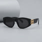 Zylos designer black cat-eye sunglasses with gold interlocking BB logo hardware and dark grey lenses, shown from a three-quarter front view.