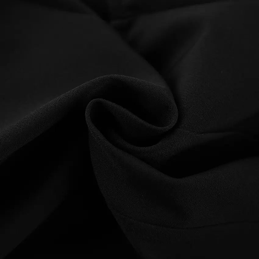 Close-up of the matte black woven fabric texture of a Zylos sleeveless vest, showing the premium material detail.