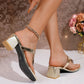 Zylos metallic gold heeled thong sandals featuring a square toe, chunky block heel, and intricate floral crystal embellishments, shown on a model's feet.
