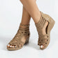 Golden Sand Zylos rhinestone wedge sandals featuring Roman-style straps, a delicate gold ankle chain, and a comfortable wedge heel.