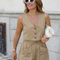 A woman smiles while wearing a khaki linen blend sleeveless V-neck vest with button front and high-waisted drawstring shorts with patch pockets, styled with sunglasses and a white handbag.