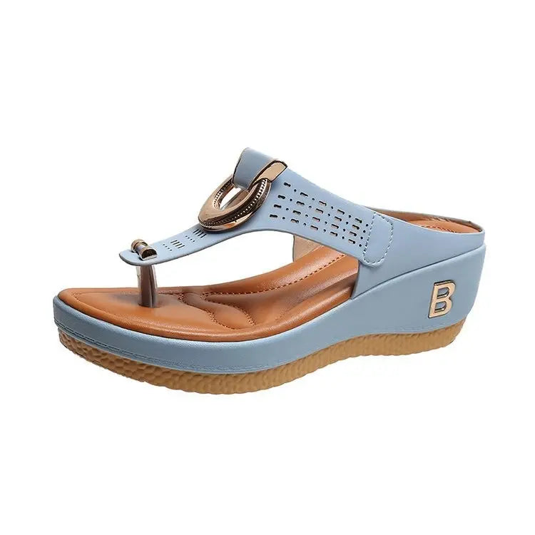 Light blue Zylos wedge platform thong sandals with a gold-tone ring hardware and perforated strap, featuring a straw-effect wedge and tan footbed.