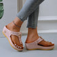 Women's light pink Zylos wedge platform thong sandals with gold ring hardware and perforated straps, worn with distressed jeans and an anklet.
