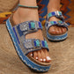 Zylpha embellished platform slide sandals in Ocean Blue, featuring twin adjustable buckle straps adorned with beads, rhinestones, and turquoise stones, set on a contoured cork footbed and a braided layered platform sole.