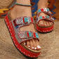 Zylpha embellished platform slide sandals in vibrant red, featuring twin adjustable silver-tone buckles, intricate bead and rhinestone detailing, and a braided cork sole.
