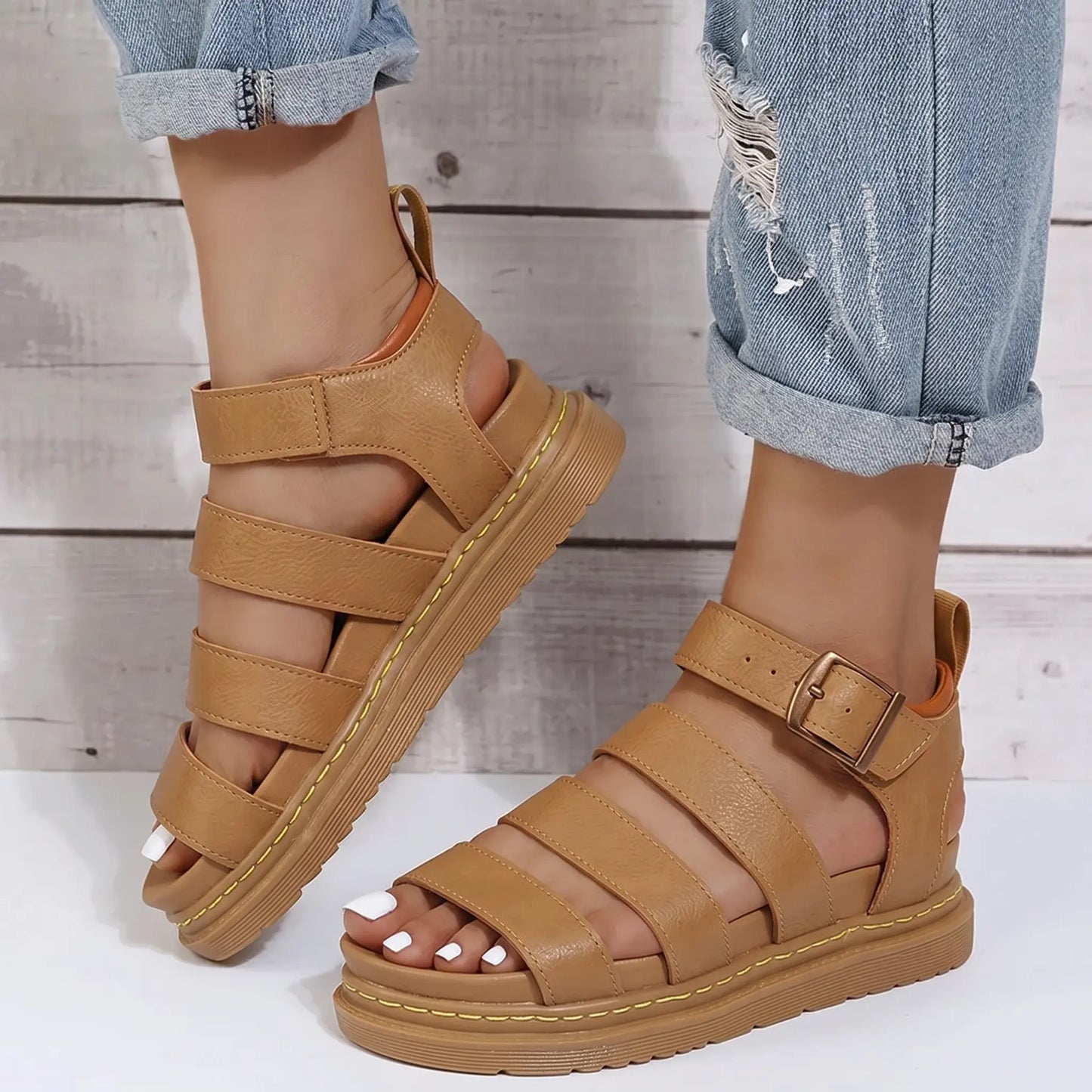 Zylphos women's tan PU leather gladiator platform sandals with a buckle ankle strap and yellow sole stitching, shown in a three-quarter view.