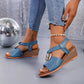 Zylva women's blue wedge sandals with gold ring detail on elastic straps, worn with denim jeans, showcasing a bohemian summer style.