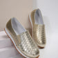Zymir women's metallic gold slip-on loafers featuring a distinctive woven upper texture and a comfortable flat rubber sole, shown from a three-quarter angle.