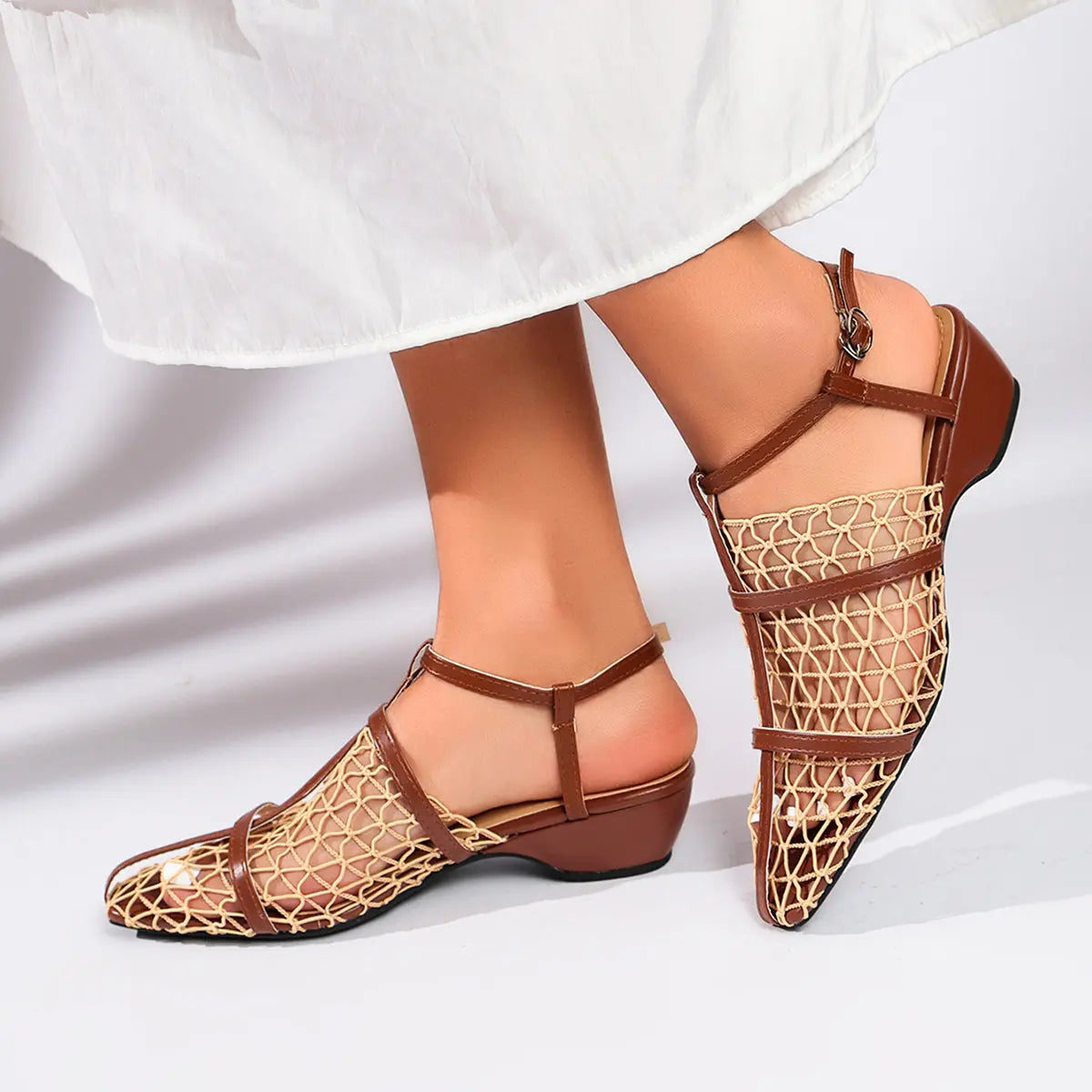 Zynthis Deep Brown mesh heeled sandals with woven straps and pointed toe, shown on a model's foot from the side with a low block heel.