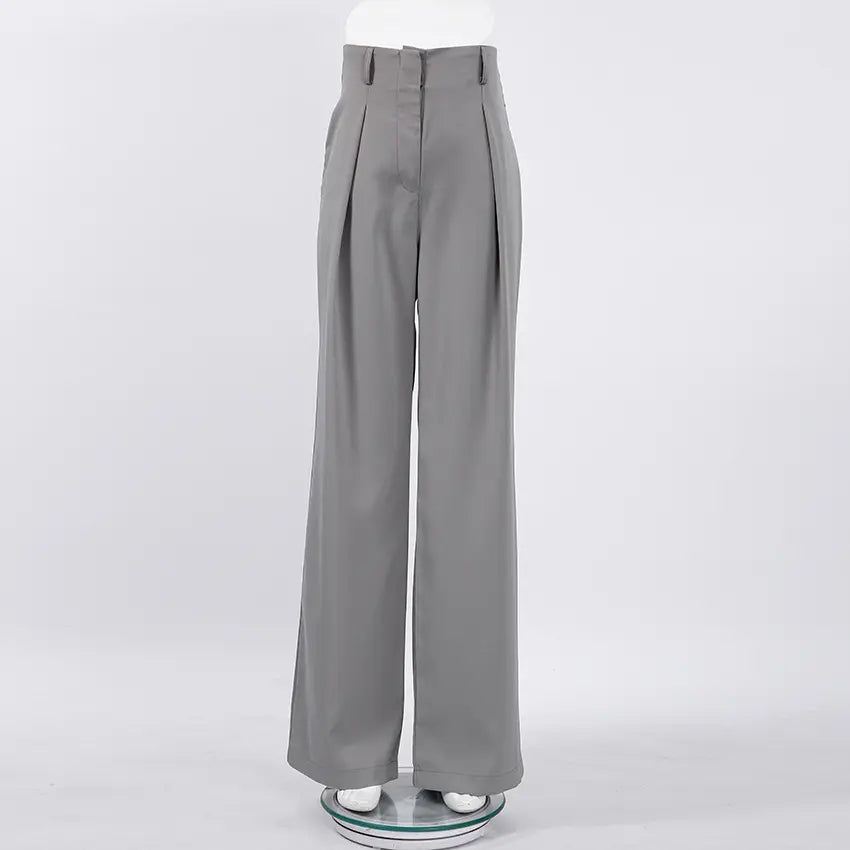 High-waisted Zyntra wide-leg trousers in a sophisticated grey hue, featuring sharp front pleats and a fluid drape, presented flat lay on a white studio background.