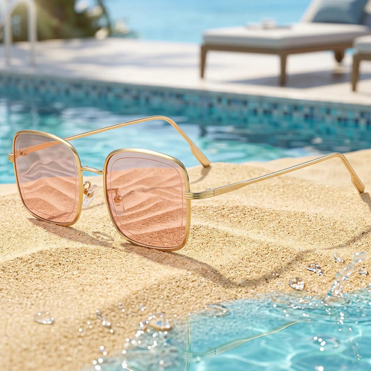 Gold frame square sunglasses with soft rose tinted lenses, shown from a three-quarter angle on a white background.
