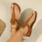 Brown suede-like gladiator sandals featuring intricate criss-cross stitching on the toe strap and braided ankle ties, shown on a model's feet with white toenails.